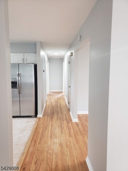 720 Walnut Street Linden, NJ 07036 - Photo 9 of 18 a view of a hallway with wooden floor