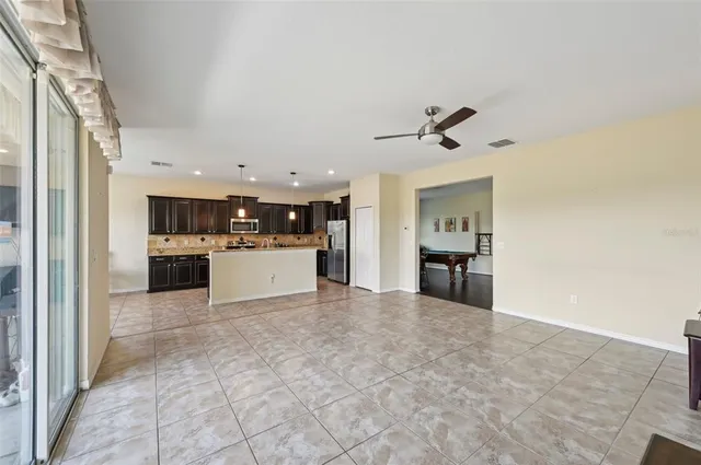 a view of a kitchen with a sink and a refrigerator a fireplace