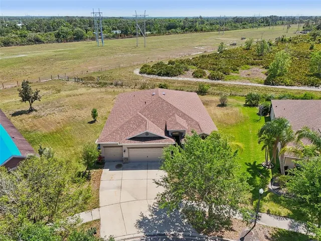 an aerial view of a houses with outdoor space and lake view