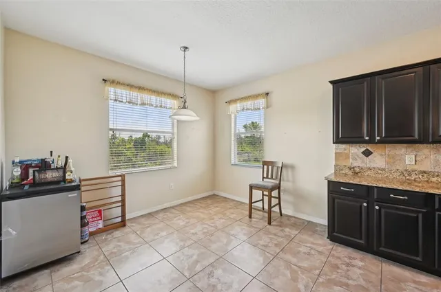 a kitchen with granite countertop a sink cabinets and appliances