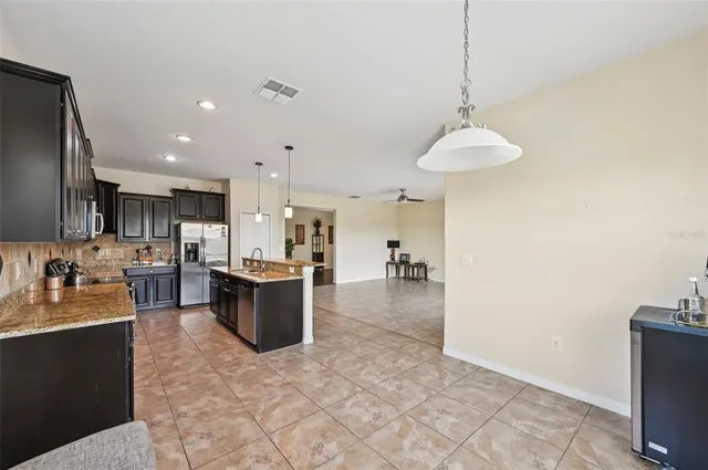 a large kitchen with a counter top space appliances and cabinets