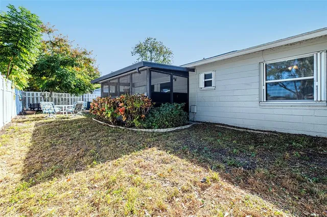 a view of a small yard in front of a house with wooden fence