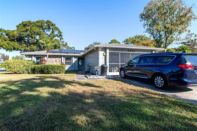 a house with green field in front of it