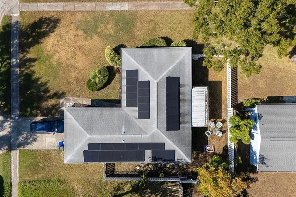 an aerial view of residential houses with outdoor space and swimming pool