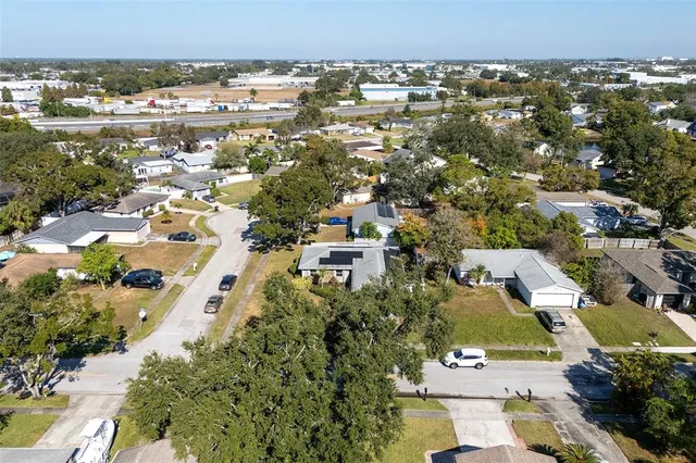 an aerial view of a house with a yard