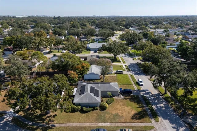 an aerial view of a houses with a lake