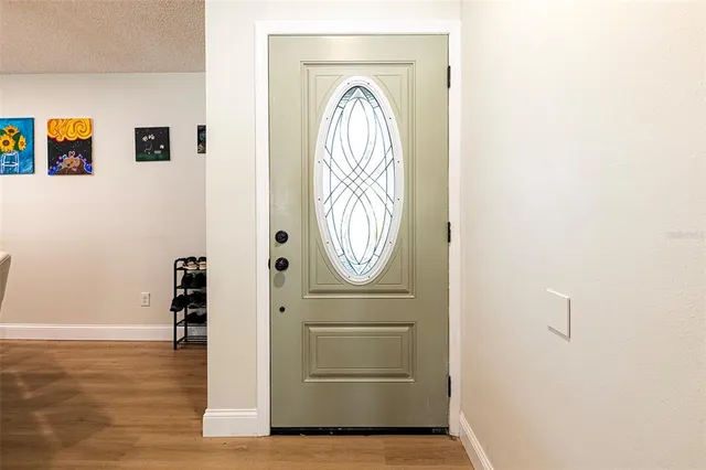 a view of front door with wooden floor