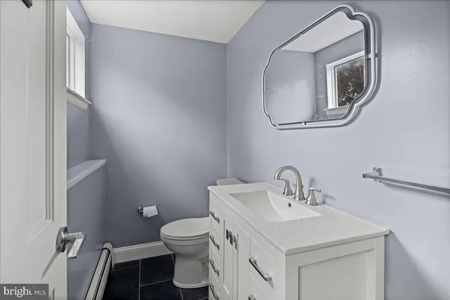 a bathroom with a sink toilet and mirror