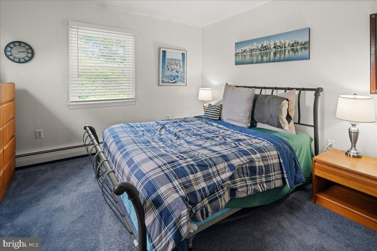 111 Howard Way Pennington, NJ 08534 - Photo 20 of 31 a bedroom with a bed and a lamp