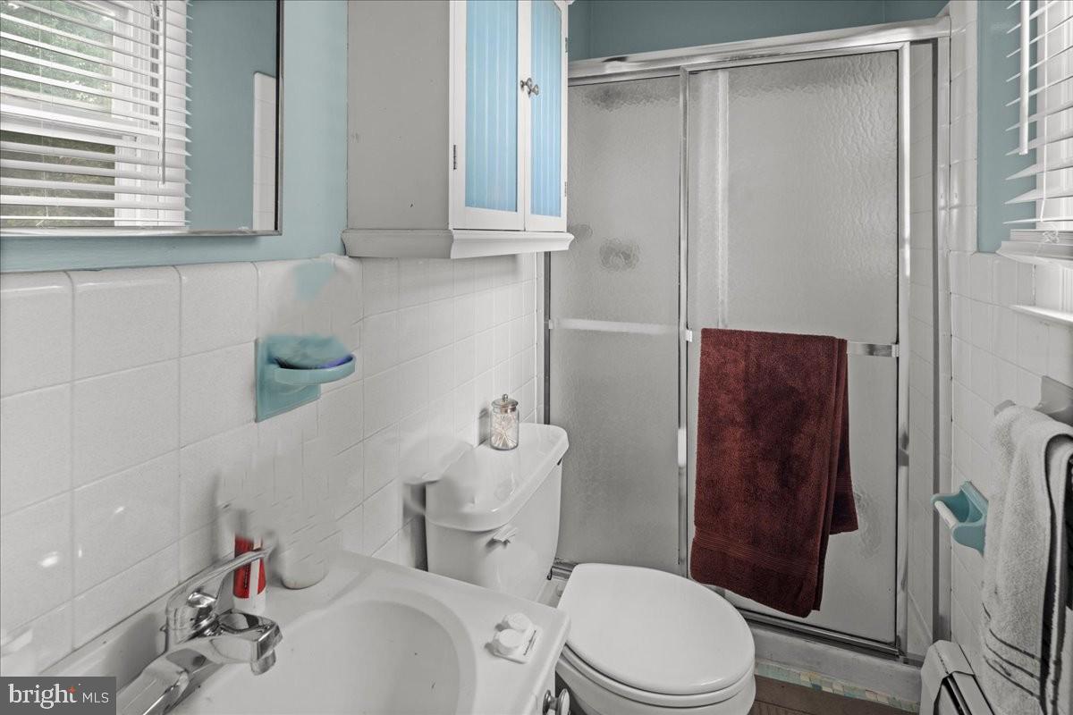 111 Howard Way Pennington, NJ 08534 - Photo 21 of 31 a white toilet sitting next to a bathroom sink