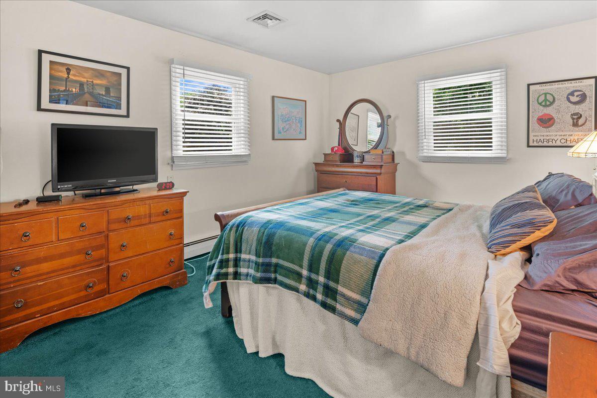 111 Howard Way Pennington, NJ 08534 - Photo 22 of 31 a bedroom with a bed and flat screen tv