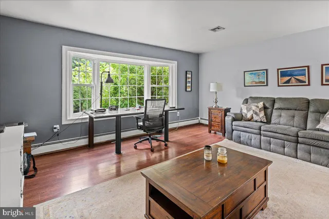 a living room with furniture a rug and a large window