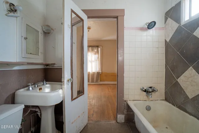 a bathroom with a bathtub and a sink
