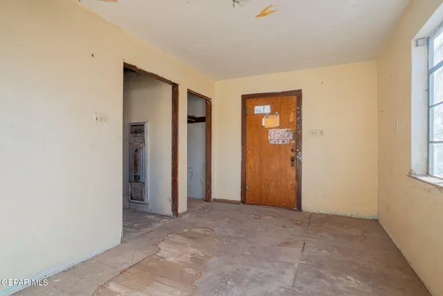 an empty room with windows and closet