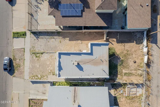 an aerial view of a house with a yard