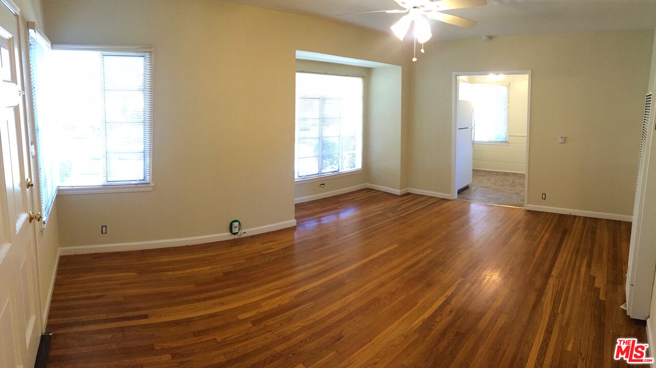 2912 West Riverside Drive Burbank, CA 91505 - Photo 10 of 16 an empty room with wooden floor and windows