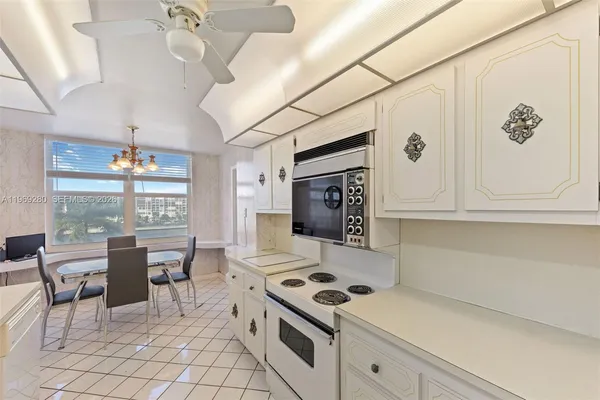 a kitchen with a cabinets and stove top oven