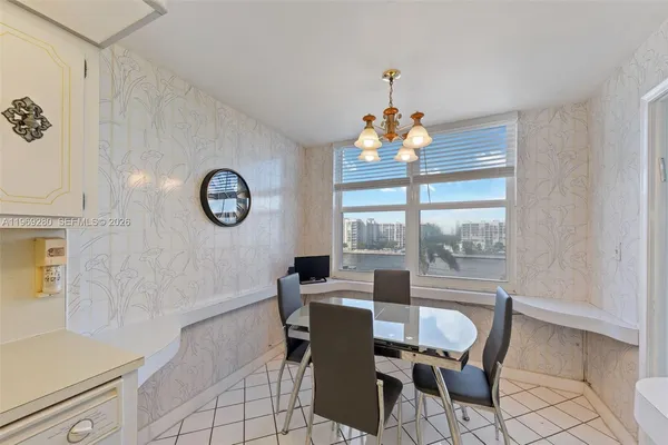 a dining room with furniture a chandelier and a rug