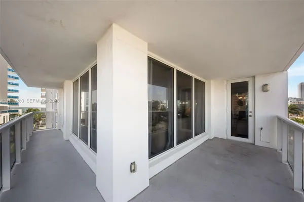 a view of a hallway with wooden shelves