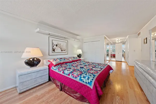 a bedroom with bed and a chandelier