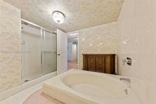 a bathroom with a tub and shower