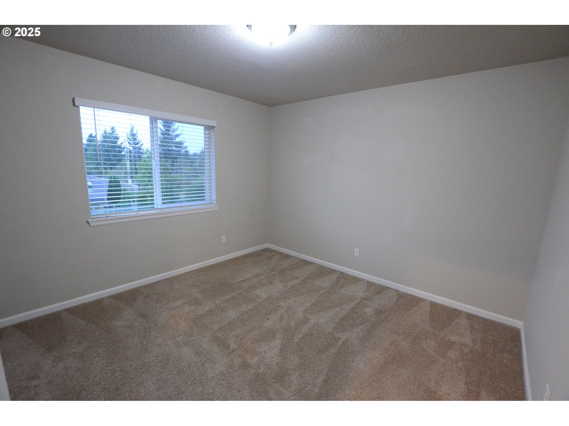 15557 Southwest Wren Lane Beaverton, OR 97007 - Photo 12 of 28 a view of an empty room with a window
