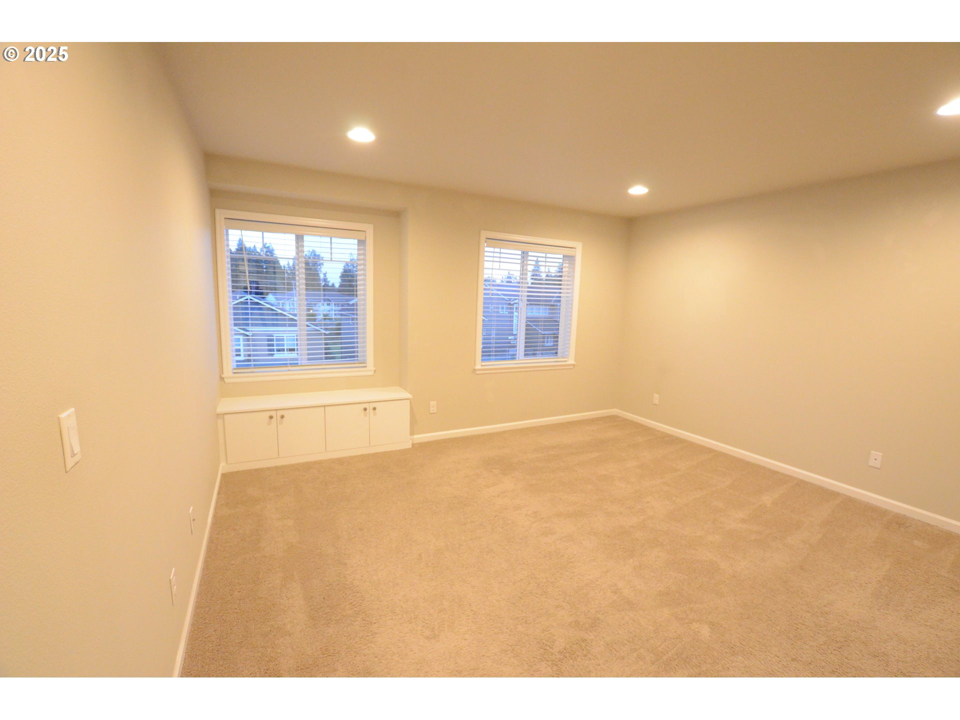 15557 Southwest Wren Lane Beaverton, OR 97007 - Photo 13 of 28 a view of an empty room with wooden floor and a window