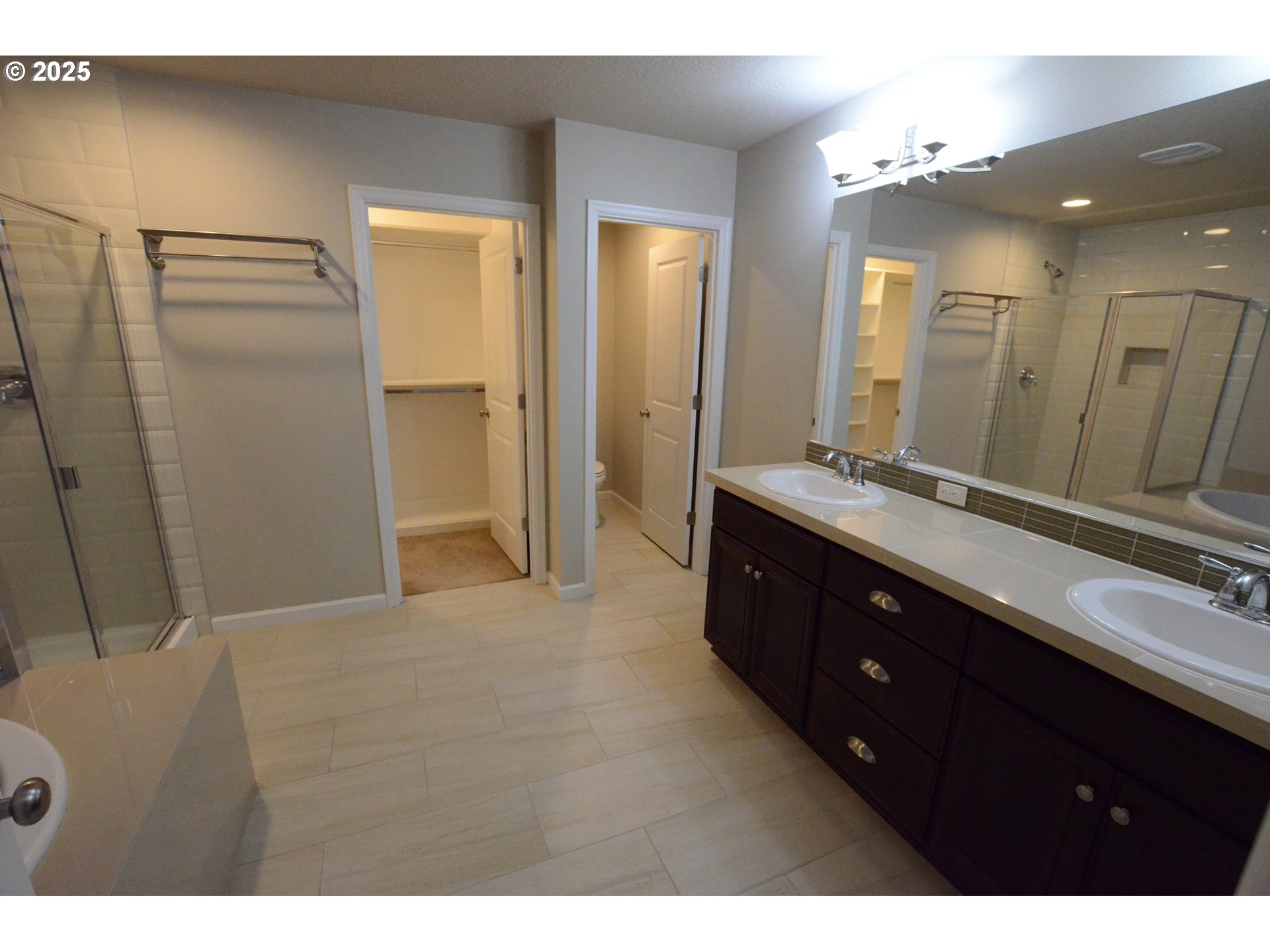 15557 Southwest Wren Lane Beaverton, OR 97007 - Photo 15 of 28 a bathroom with a double vanity sink a toilet and a mirror