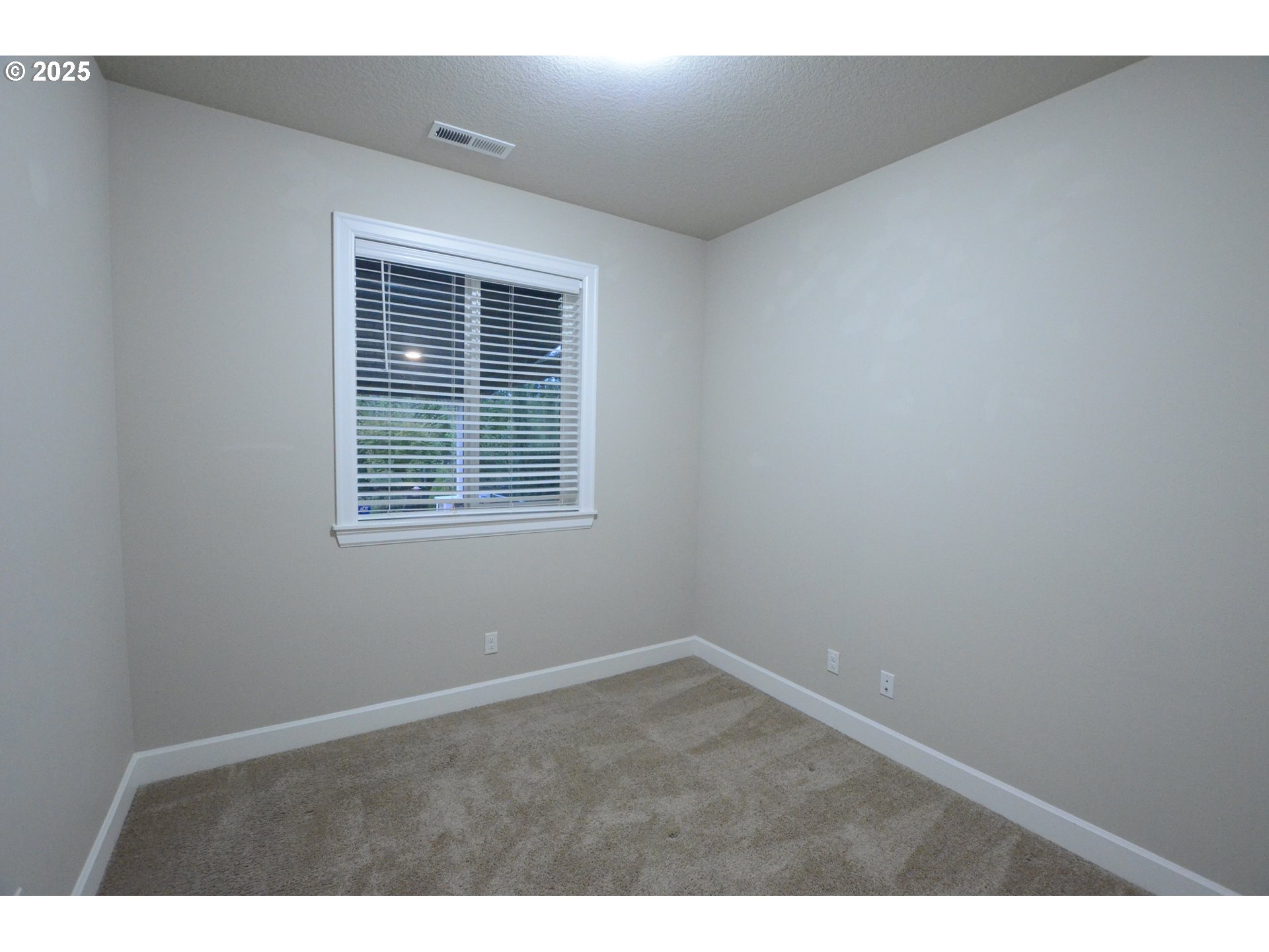 15557 Southwest Wren Lane Beaverton, OR 97007 - Photo 8 of 28 a view of an empty room with a window