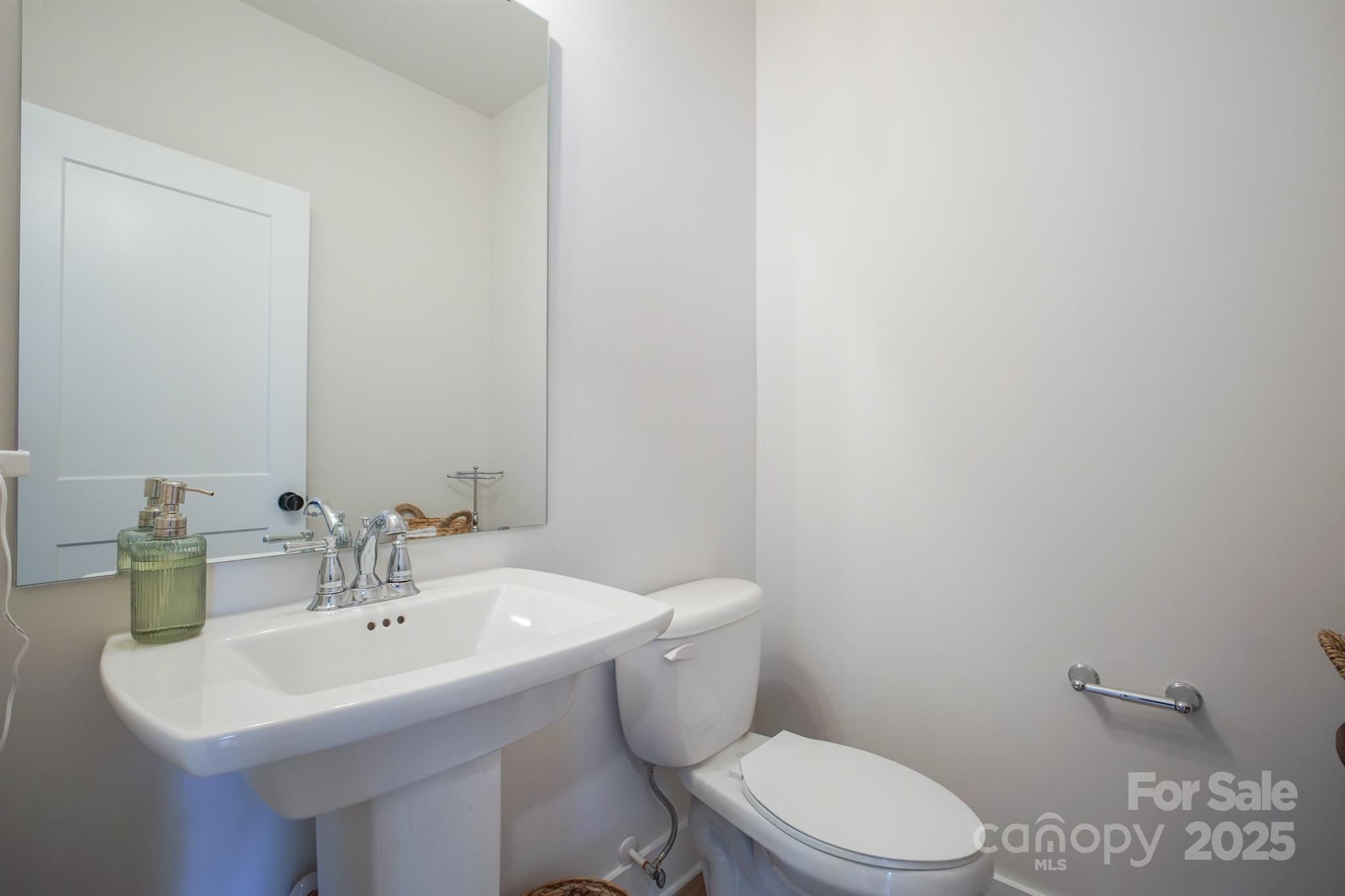 711 Beaty Street Davidson, NC 28036 - Photo 14 of 22 a bathroom with a sink a toilet and mirror