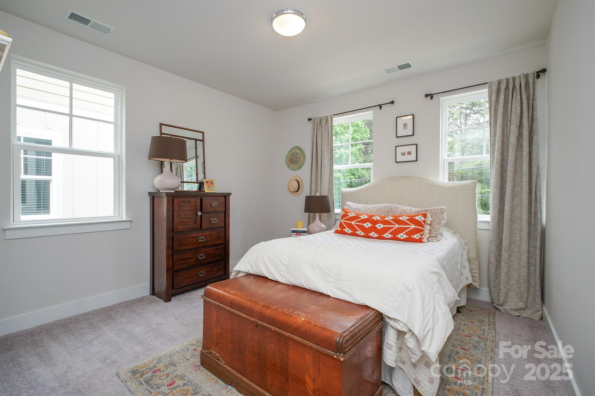 711 Beaty Street Davidson, NC 28036 - Photo 15 of 22 a bedroom with a bed and a dresser next to a window