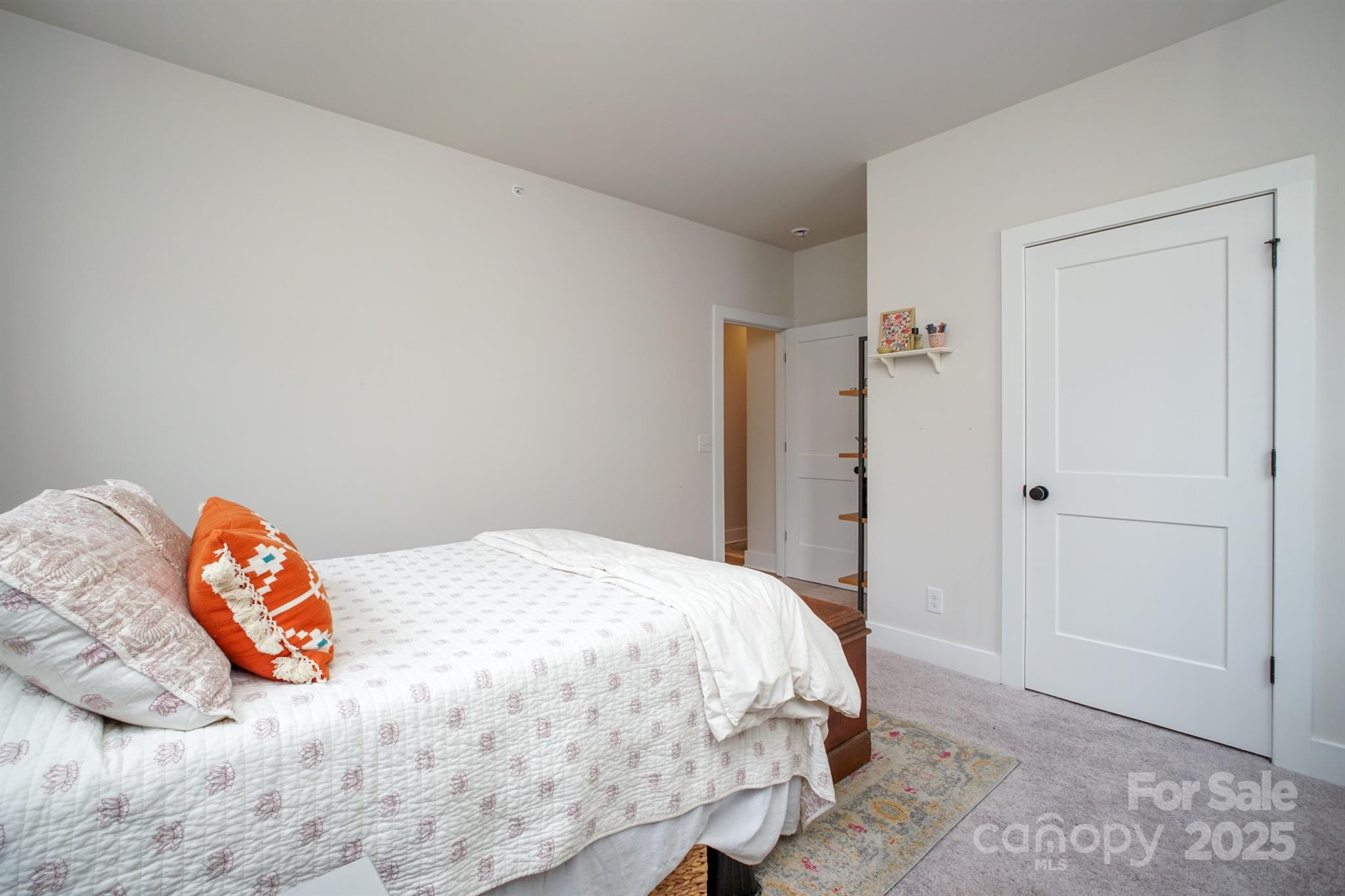 711 Beaty Street Davidson, NC 28036 - Photo 17 of 22 a bedroom with a bed and a couch