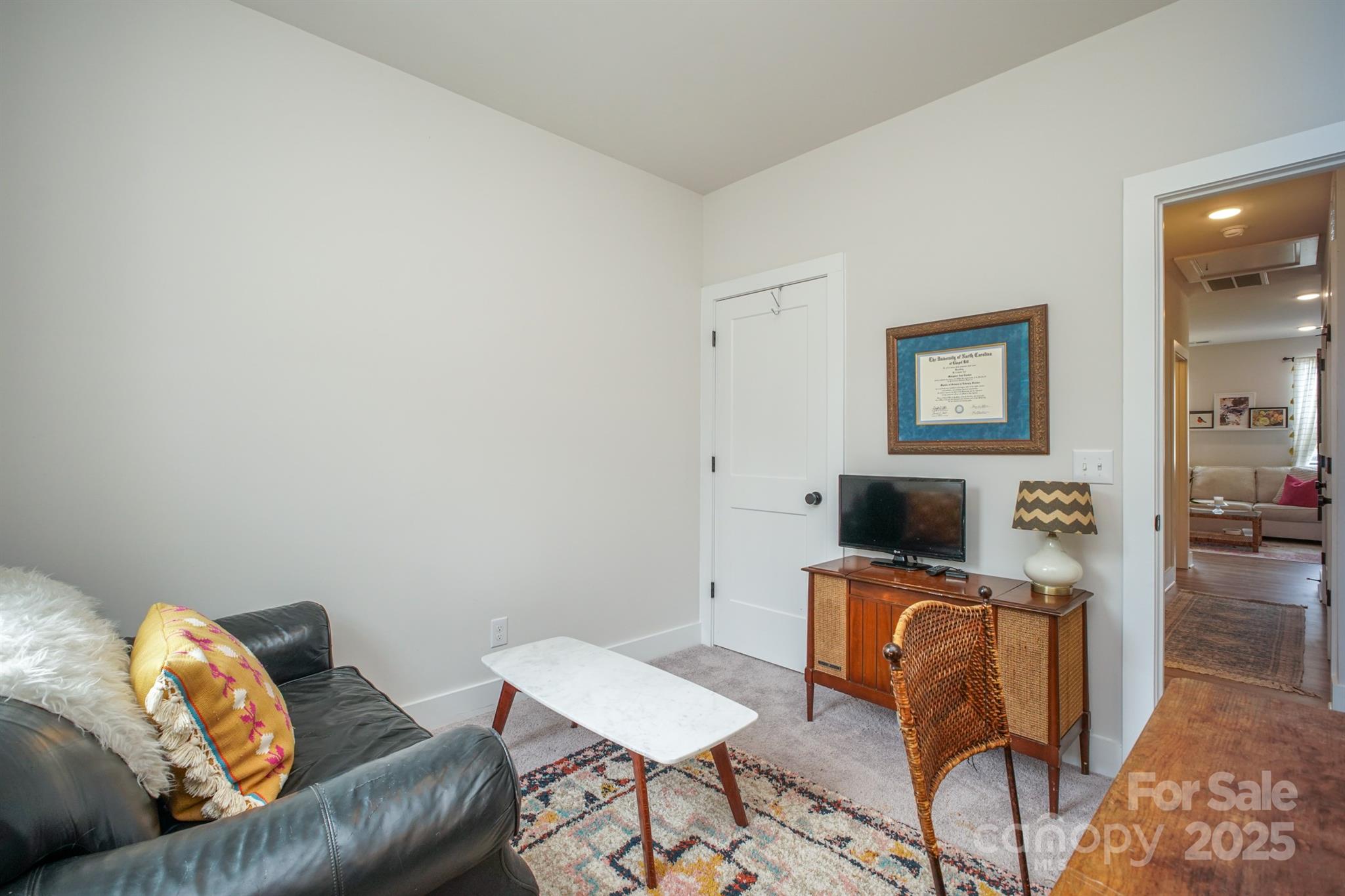 711 Beaty Street Davidson, NC 28036 - Photo 21 of 22 a living room with furniture and a flat screen tv