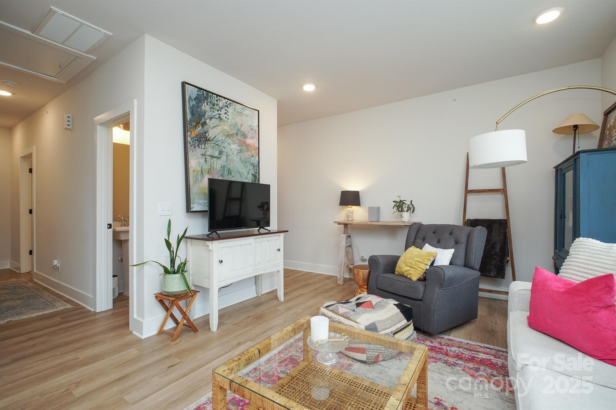 711 Beaty Street Davidson, NC 28036 - Photo 5 of 22 a living room with furniture a flat screen tv and wooden floor