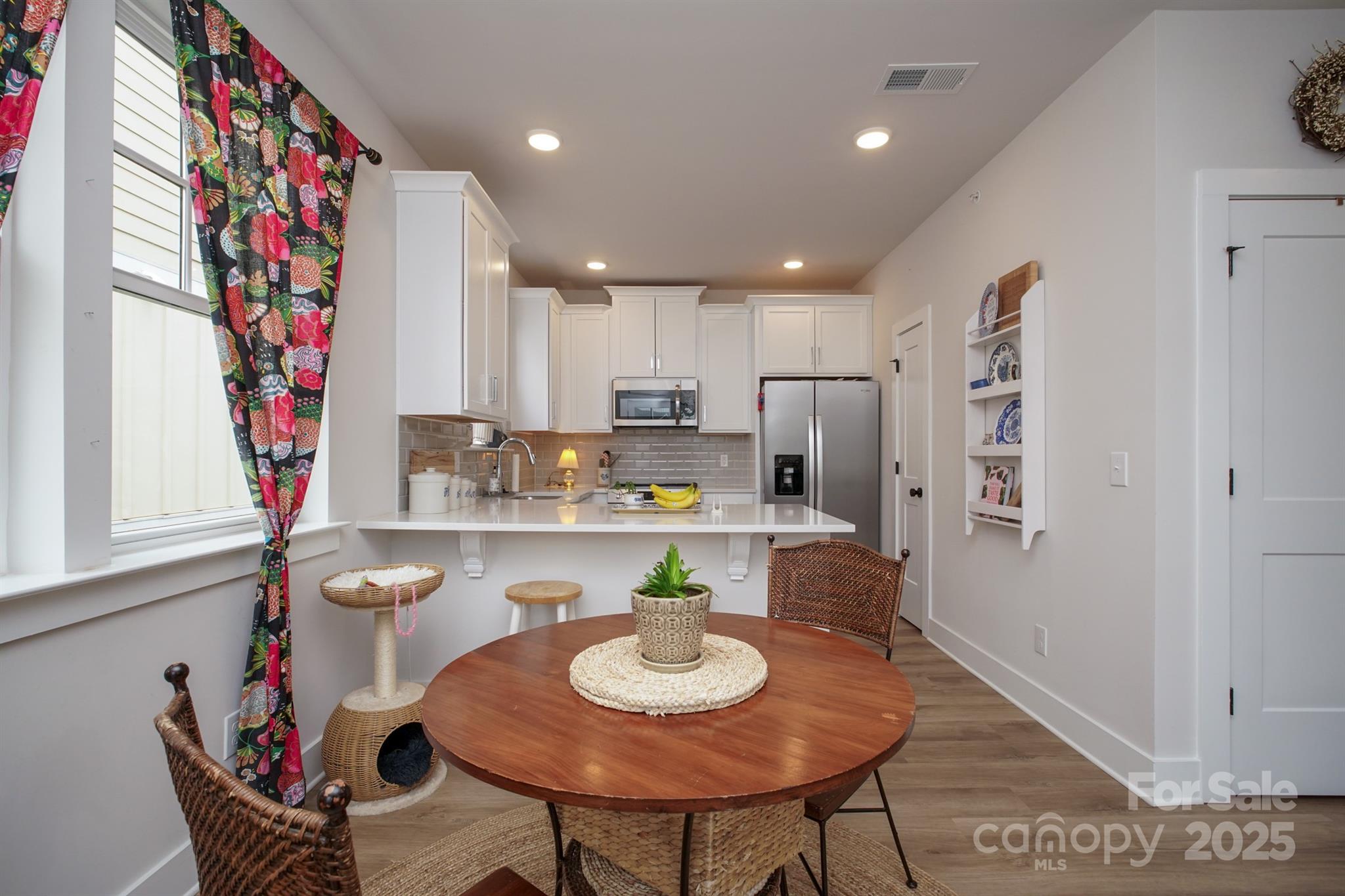 711 Beaty Street Davidson, NC 28036 - Photo 8 of 22 a view of a dining room with furniture and a potted plant