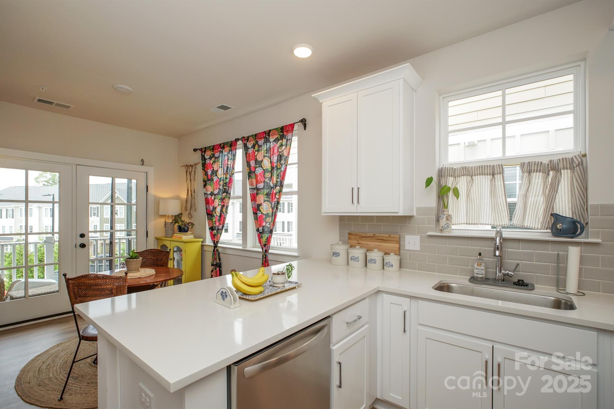 711 Beaty Street Davidson, NC 28036 - Photo 9 of 22 a kitchen with a sink a counter and chairs