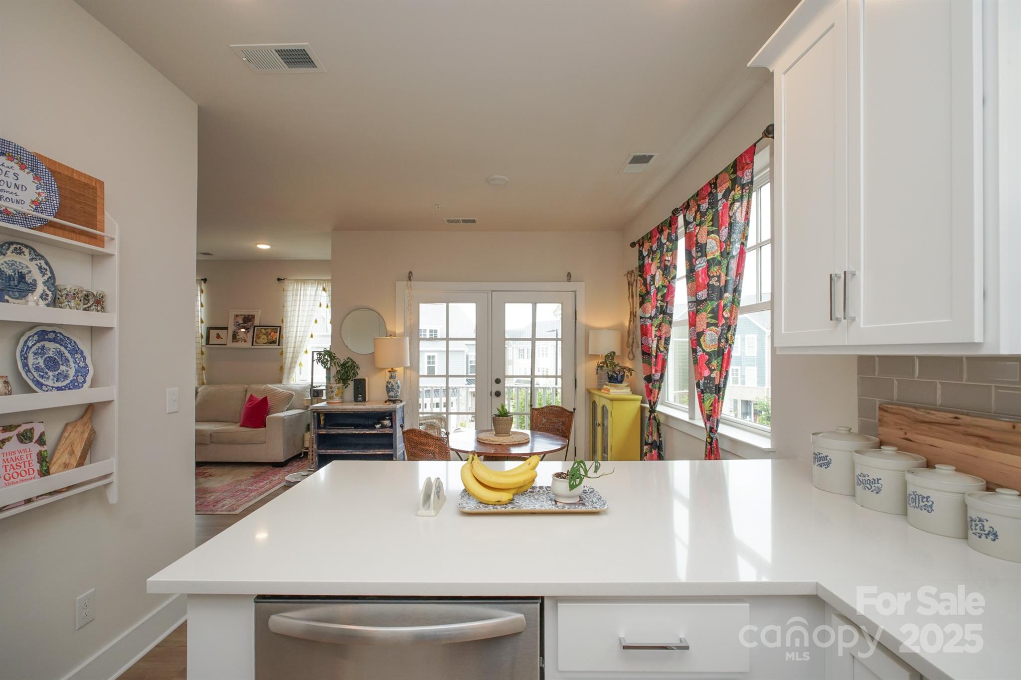 711 Beaty Street Davidson, NC 28036 - Photo 10 of 22 a view of a kitchen with kitchen island a large window a sink and a counter space