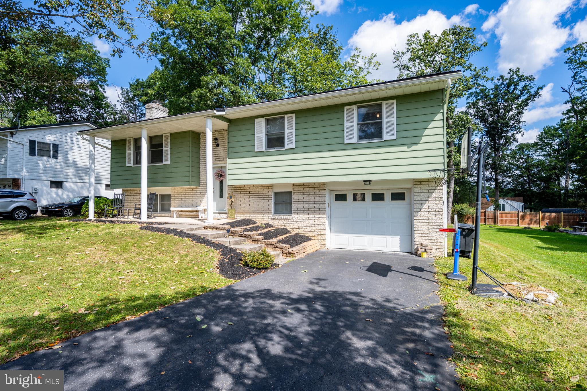 15105 Laurel Ridge Road Southwest Cumberland, MD 21502 - Photo 1 of 54 a view of a house with backyard and a tree