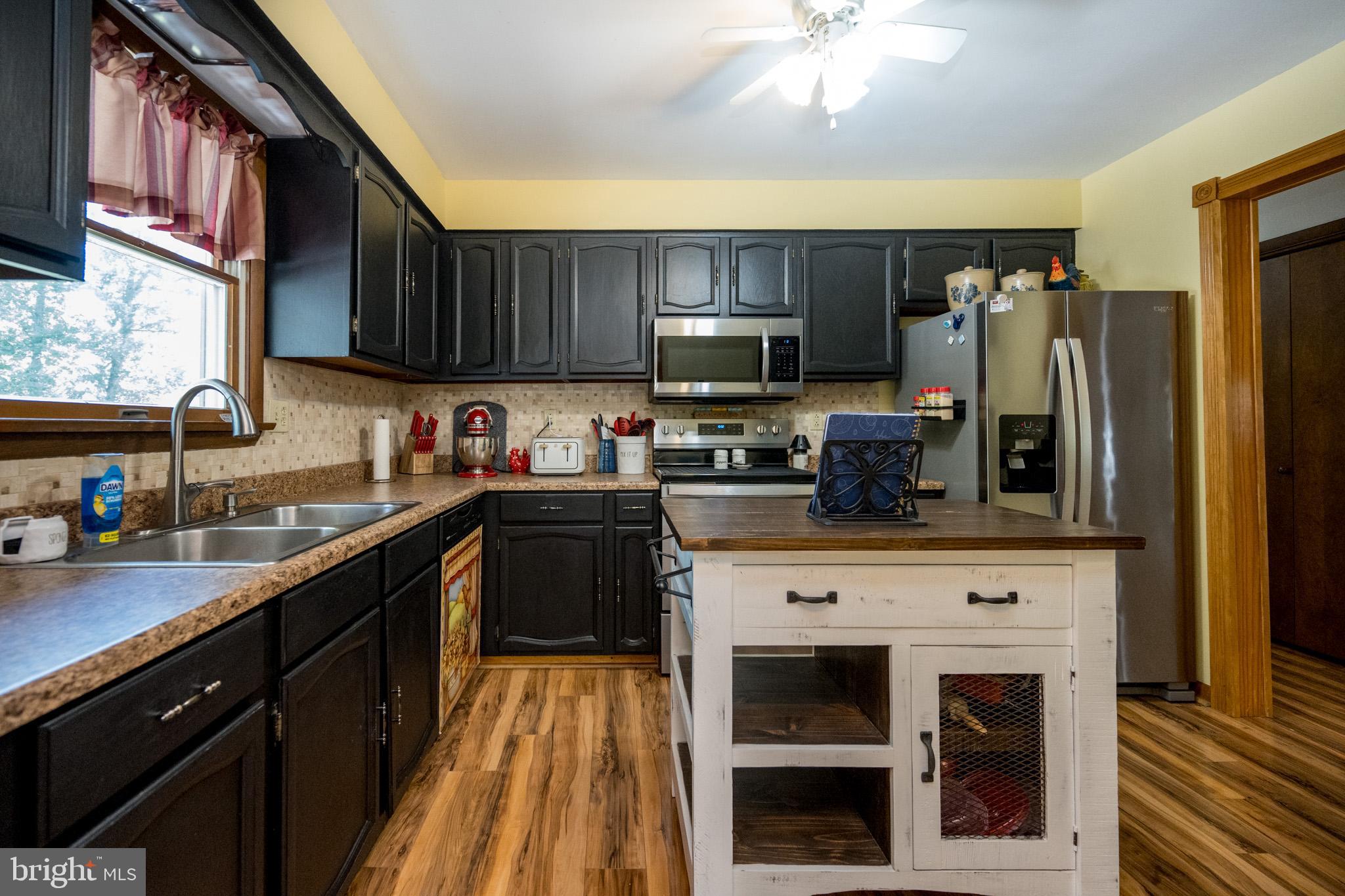 15105 Laurel Ridge Road Southwest Cumberland, MD 21502 - Photo 16 of 54 a kitchen with stainless steel appliances granite countertop a stove refrigerator sink and microwave