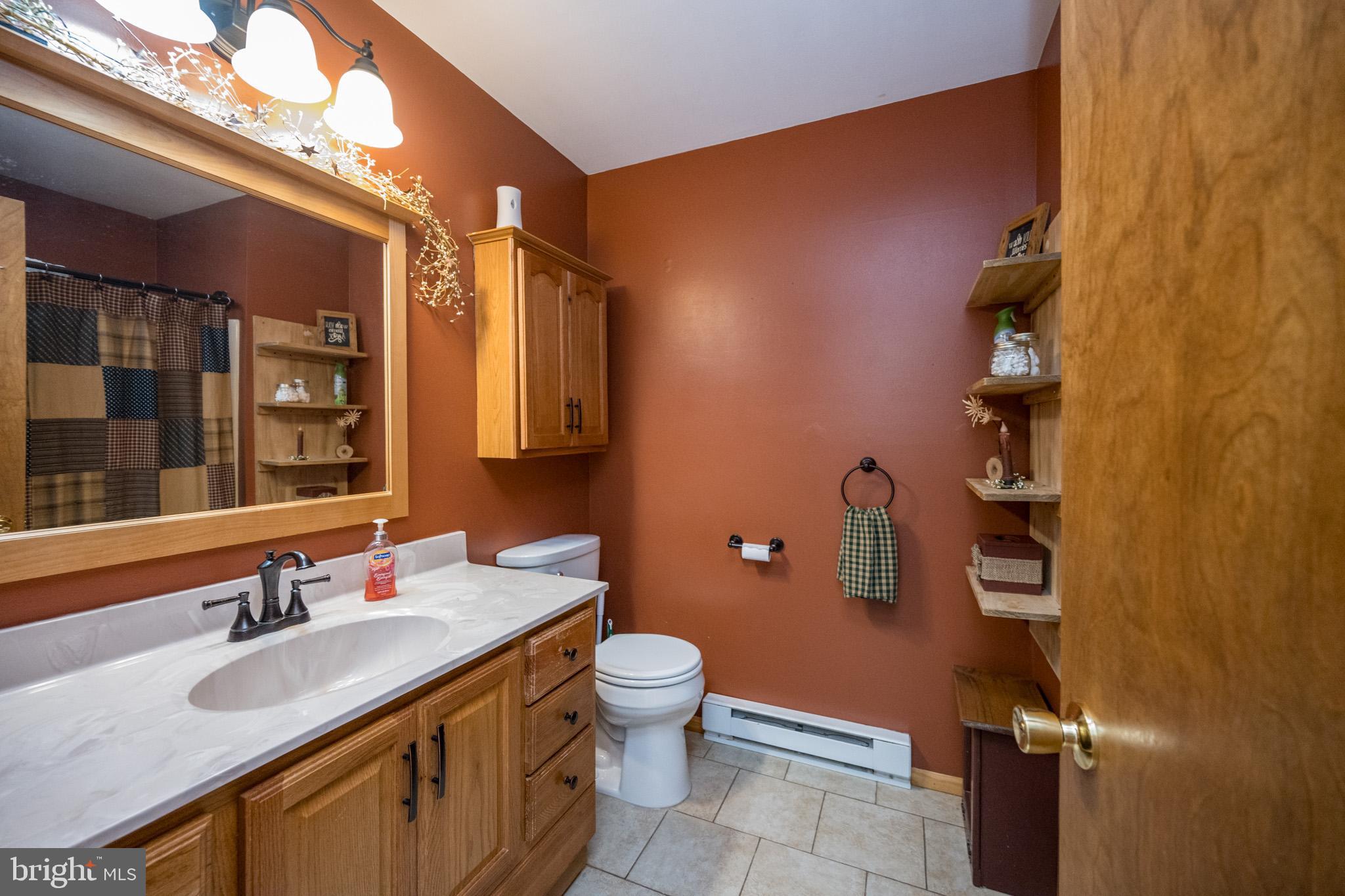 15105 Laurel Ridge Road Southwest Cumberland, MD 21502 - Photo 38 of 54 a bathroom with a granite countertop sink toilet and shower