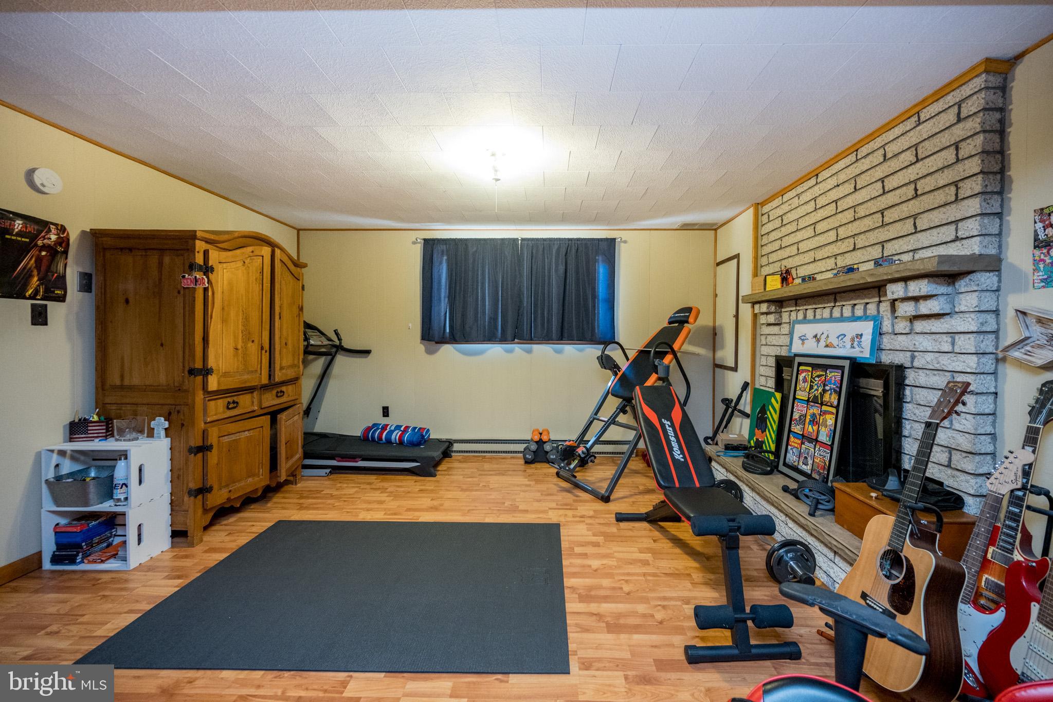 15105 Laurel Ridge Road Southwest Cumberland, MD 21502 - Photo 46 of 54 a room with gym equipment and a flat screen tv