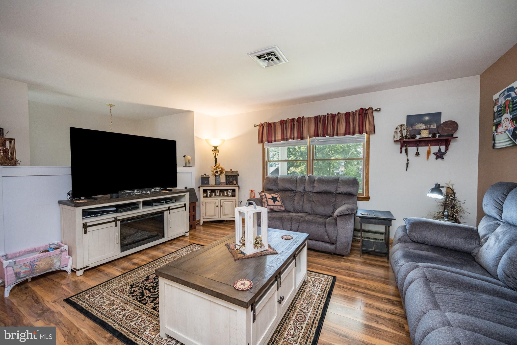 15105 Laurel Ridge Road Southwest Cumberland, MD 21502 - Photo 7 of 54 a living room with furniture and a flat screen tv