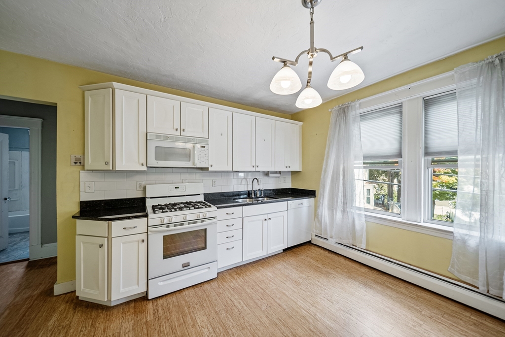 52 High Street, Unit 5 Methuen, MA 01844 - Photo 14 of 32 a kitchen with stainless steel appliances granite countertop a stove and a white cabinets