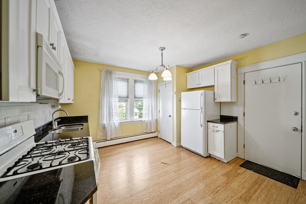 52 High Street, Unit 5 Methuen, MA 01844 - Photo 15 of 32 a kitchen with stainless steel appliances granite countertop a refrigerator stove sink and cabinets