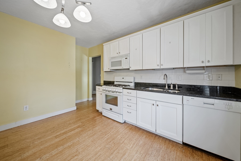 52 High Street, Unit 5 Methuen, MA 01844 - Photo 16 of 32 a kitchen with granite countertop white cabinets and white appliances