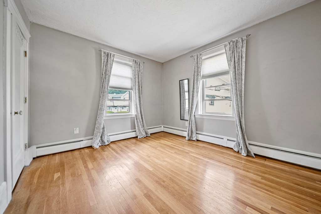52 High Street, Unit 5 Methuen, MA 01844 - Photo 20 of 32 an empty room with wooden floor and windows