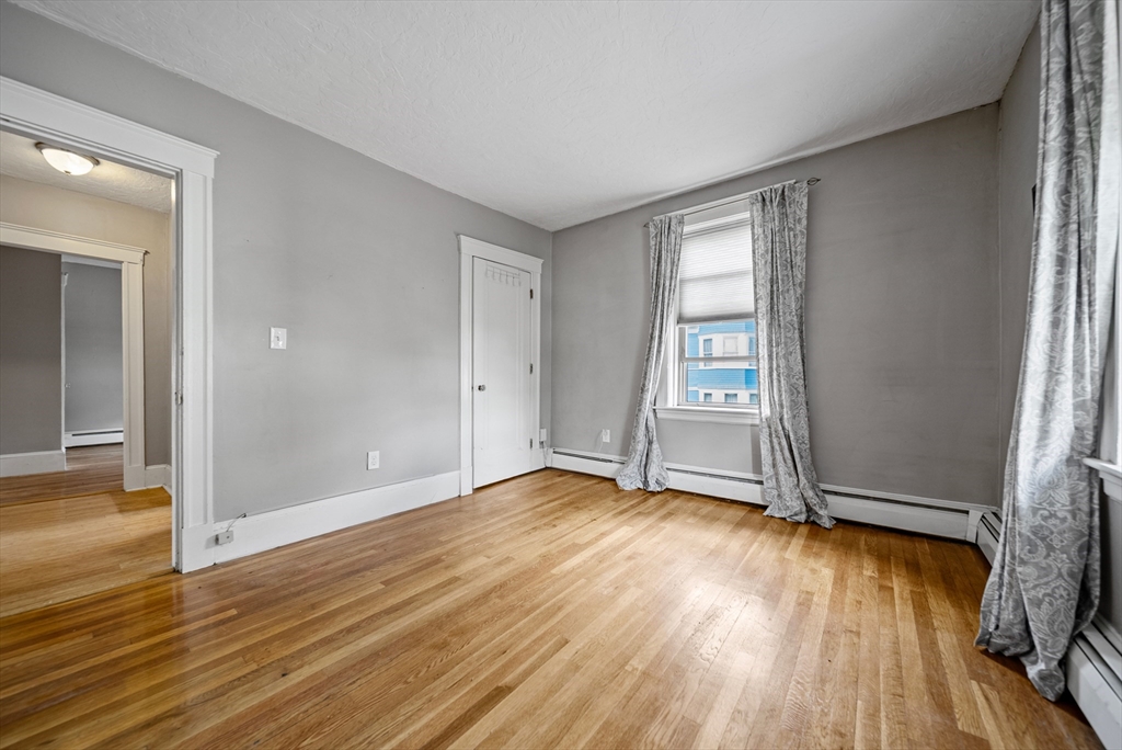 52 High Street, Unit 5 Methuen, MA 01844 - Photo 22 of 32 an empty room with wooden floor and door