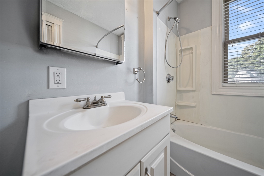 52 High Street, Unit 5 Methuen, MA 01844 - Photo 24 of 32 a bathroom with a sink and a mirror
