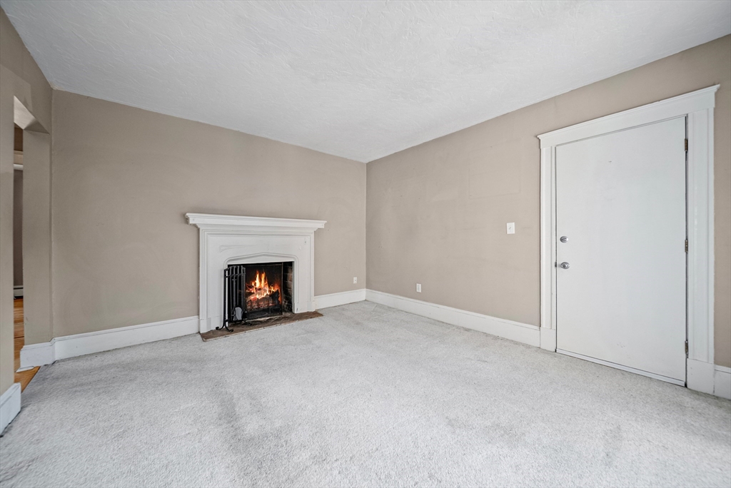 52 High Street, Unit 5 Methuen, MA 01844 - Photo 30 of 32 a view of an empty room with a fireplace and a window