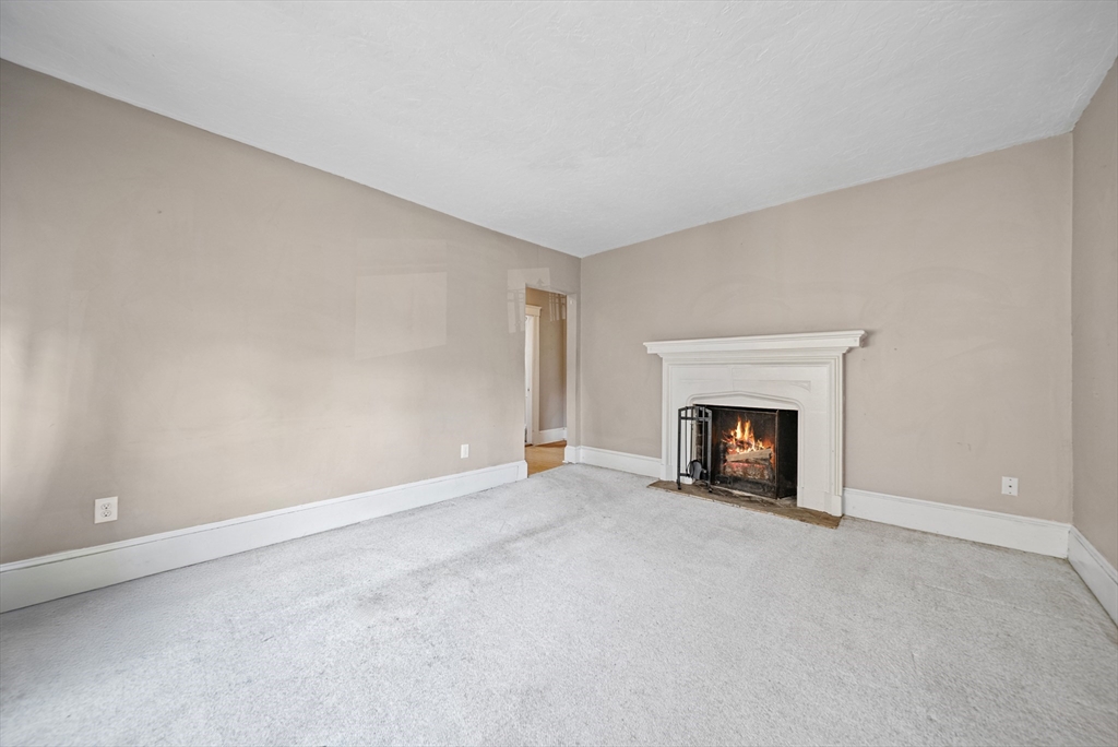 52 High Street, Unit 5 Methuen, MA 01844 - Photo 31 of 32 a view of an empty room with a fireplace and a window
